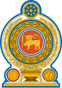 Coat of arms of Sri Lanka, showing a lion holding a sword in its right forepaw surrounded by a ring made from blue lotus petals which is placed on top of a grain vase sprouting rice grains to encircle it. A Dharmacakra is on the top while a sun and moon are at the bottom on each side of the vase.